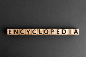 Encyclopedia - word from wooden blocks with letters, collection of information encyclopedia concept,  top view on grey background