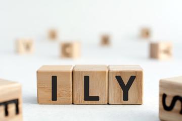 ILY - abbreviation from wooden blocks with letters, I love you ILY concept,  white background