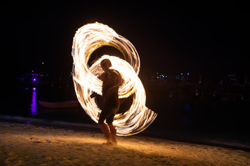 Amazing fire dancers Swing fire dancing show fire show on the beach  in Thailand