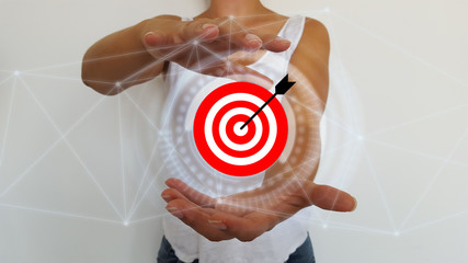 Bussinesswoman holding in hands target and arrow with digital interface