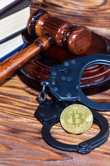 bitcoin, judge's hammer, handcuffs. Concept bitcoin ban, violation of the law.
