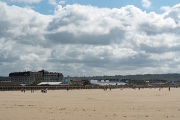 view of the expansive sandy beaches at Deauville in Normandy on a beautiful summer day