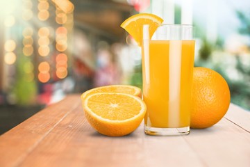 Glass of delicious orange juice on natural background
