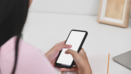 Young woman using isolated screen mobile phone with clipping path for montage.