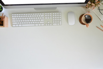 Work desk top view with computer and equipment, coffee, pencil with flower, Hero header.