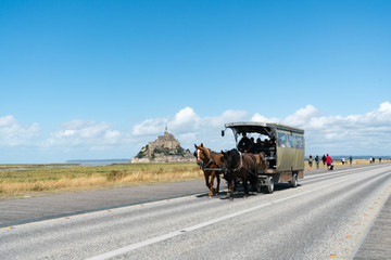 horse and carriage transporting tourists to the famous Mont Saint-Michel in northern France