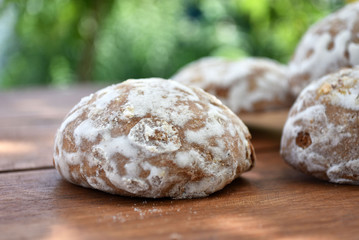 Heap of honey-cake on wooden table. Russian spice-cakes with frosting. Closeup.