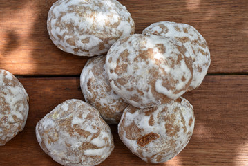 Heap of honey-cake on wooden table. Russian spice-cakes with frosting. Closeup.