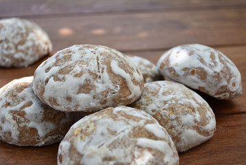 Heap of honey-cake on wooden table. Russian spice-cakes with frosting. Closeup.