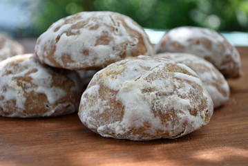 Heap of honey-cake on wooden table. Russian spice-cakes with frosting. Closeup.