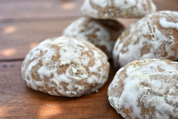 Heap of honey-cake on wooden table. Russian spice-cakes with frosting. Closeup.