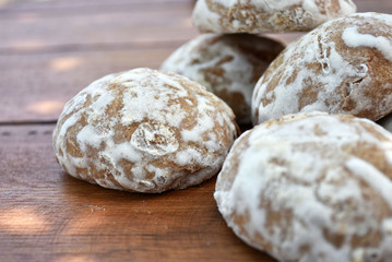 Heap of honey-cake on wooden table. Russian spice-cakes with frosting. Closeup.