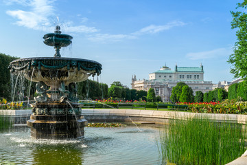 Fototapeta na wymiar Historical building and fountain in Volksgarten Vienna park, Austria