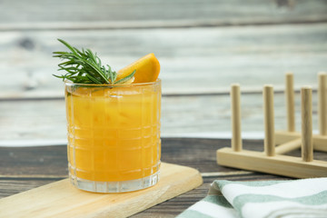 Fresh summer cocktail with orange juice and ice cubes in glass