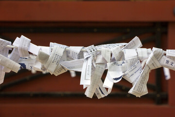Unfortunate forecast of Japanese cast lot (or Omikuji) are left behind at temple or shrine, tied up...