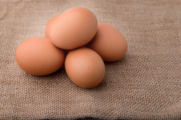 Fresh eggs on sackcloth. Copy the area for the text on the background, sackcloth, brown.
