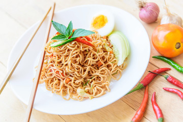 fried noodles with chilli on wood table