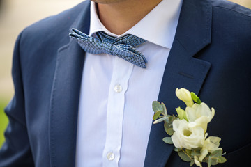 groom in a jacket, boutonniere on a jacket, the groom adjusts his jacket, The morning of the groom,...