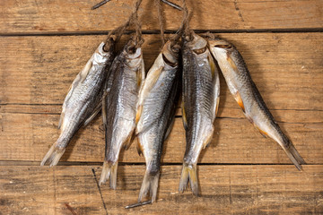 Close-up dried river fish on old wooden background.