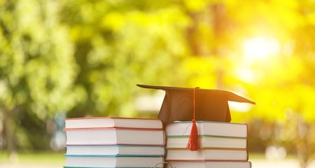 Graduation hat and stack of books
