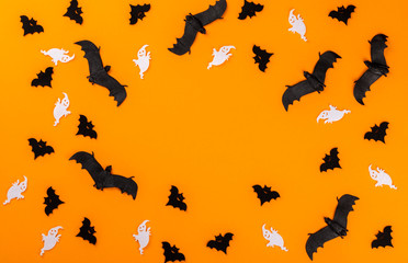 Halloween postcard. Тraditional festival of autumn. Decoration and party concept .Bats  on a orange background .Flat lay, top view, copy space