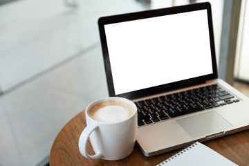 White cappuccino coffee cup, Laptop computer white space on the table at the coffee shop.