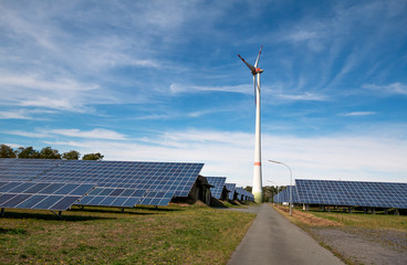 Fototapeta na wymiar Solar energy panel photovoltaic cell and wind turbine farm