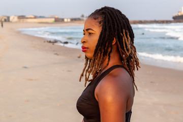 Closeup of young African lady in sportswear on the beach