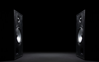 Two sound speakers with free space between them on black  background.