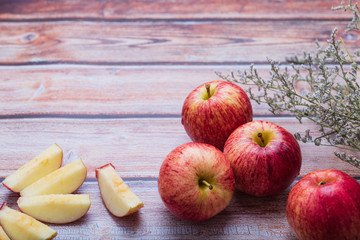 Fresh apples. Red apple fruit cut into two pieces, separate on wooden background.
