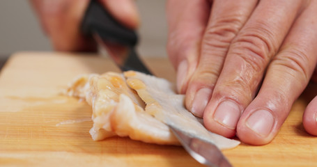 Cutting Fresh Geoduck on wooden board