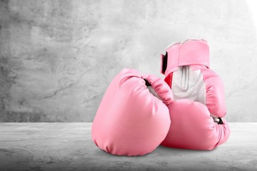 Pink boxing gloves on background