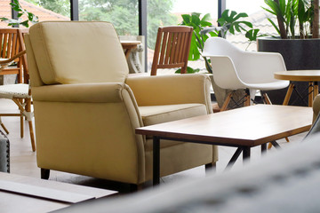Yellow armchair and coffee table in a living room interior