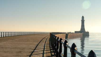Roker Pier with black metal railing in Sunderland, Tyne and Wear, England UK.  With Roker...