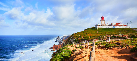 Cabo da Roca, Portugal. Lighthouse and cliffs over Atlantic Ocean, the most westerly point of the European mainland. - obrazy, fototapety, plakaty