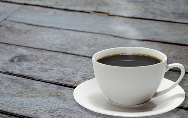 Cup of Black Coffee on old wooden with smoke