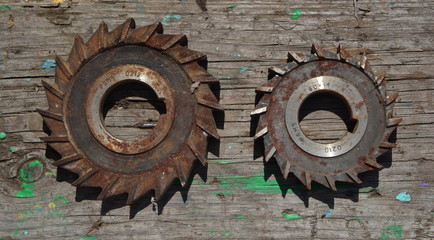 closeup of an old rusty gears on a wooden background