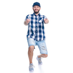 Man in jeans shorts, cap, casual clothing standing smiling showing pointing on white background isolation