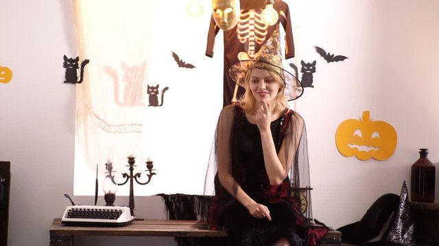 Mother and son play hide and seek on halloween background. Halloween family party and funny people. Children play with mother and have fun. Mom and child boy near pumpkin and halloween decoration.