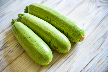 Fresh zucchini on wooden background. Top view.
