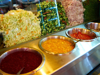 Salad bar with fresh organic vegetables in a street food restaurant