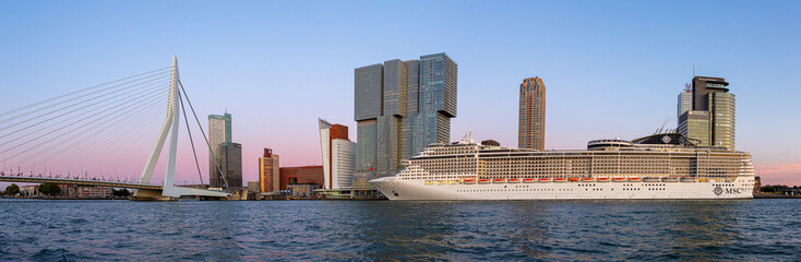 Panorama cityscape with cruise ship in front of the Dutch port city skyline of Rotterdam with...