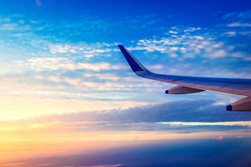 Fototapeta premium View of plane wing and beautiful sky above the clouds from plane in Udaipur ,India