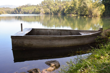Old wooden boat anchored