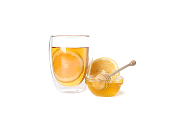 Glass of tea with lemon, honey and dipper isolated on white background