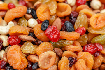 A mixture of dried apricots, raisins and nuts. Background
