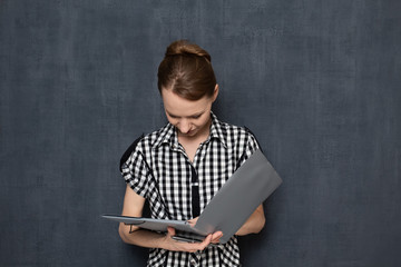 Portrait of young woman attentively reading document