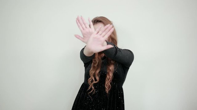 girl brown haired in black dress over isolated white background shows emotions