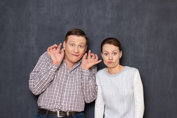 Portrait of funny couple fooling and making foolish faces