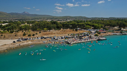 Aerial bird's eye view photo taken by drone of stand up paddle surfers in annual SUP crossing competition in Corinth Canal, Greece